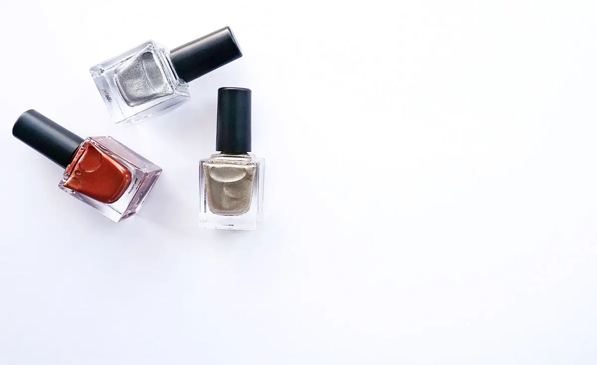 Three nail polish bottles arranged on a white background.