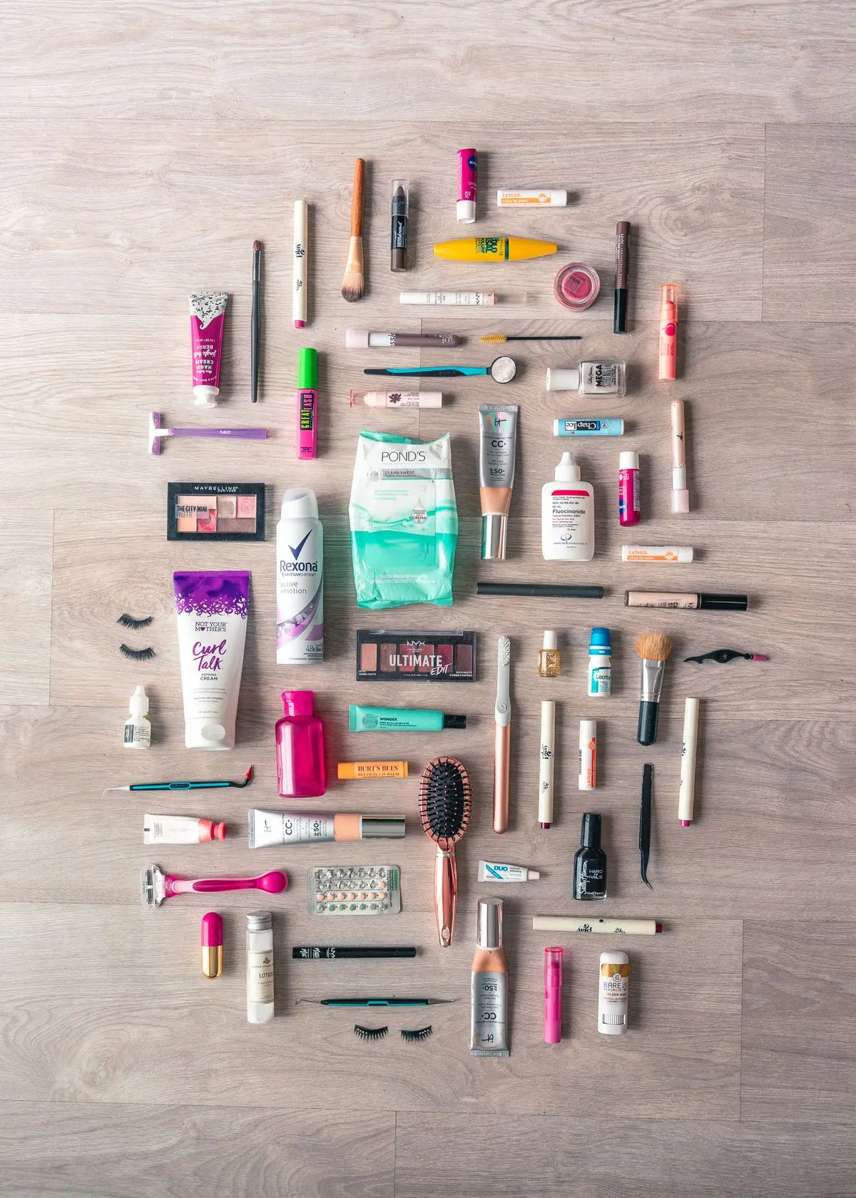 A tidy arrangement of grooming and beauty products on wood.