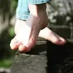 Soft soles on rough wood.