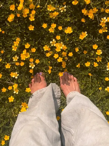 Barefoot bliss in buttercup fields 💜
