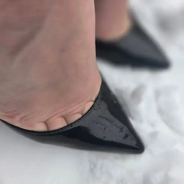Black patent heels on crisp white snow. ❄️
